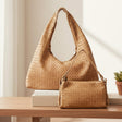 Light Brown woven handbags on a wooden surface with a neutral background