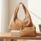 Light Brown woven handbags on a wooden surface with a neutral background