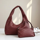 Red woven handbag on a light surface with a neutral background