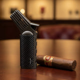 Cigar lighter with a cigar on a wooden surface, blurred background