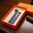 Cigar lighter with 'lubinski' branding in an orange box on a wooden surface