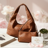 Brown woven handbag on a light surface with a 'Happy Mother's Day' card and flowers in the background