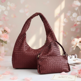 Red woven handbag on a light surface with floral decorations