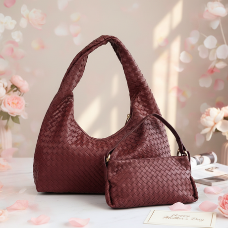 Red woven handbag on a light surface with floral decorations