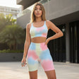 Woman wearing a colorful tie-dye athletic outfit standing outdoors.