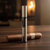 Silver cigar lighter and unlit cigar on a wooden surface with a warm background