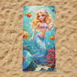 Turquoise beach towel with a blonde mermaid, clownfish and red coral on sand