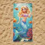 Turquoise beach towel with a blonde mermaid, clownfish and red coral on sand