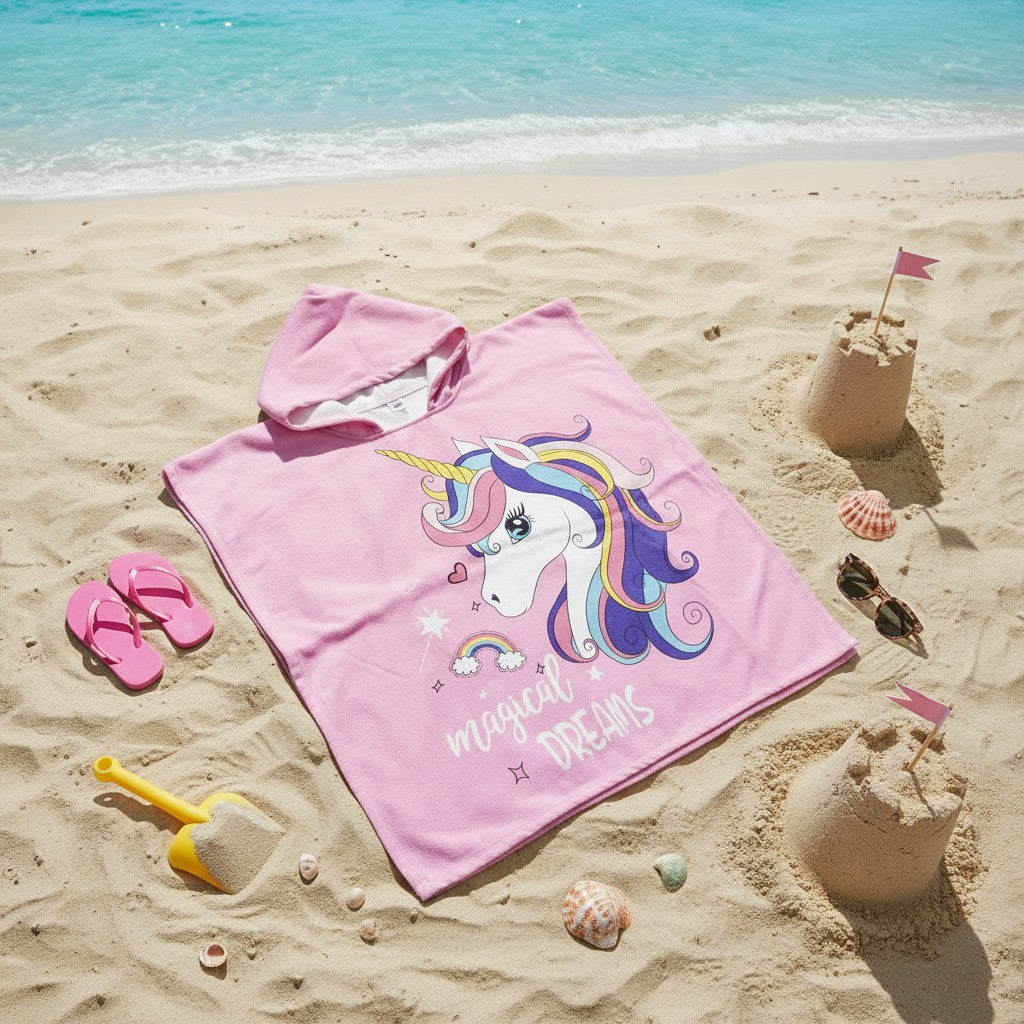 Pink rainbow unicorn hooded towel poncho for kids on the sand