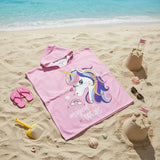 Pink rainbow unicorn hooded towel poncho for kids on the sand