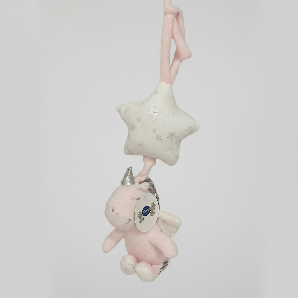 Pink plush unicorn hanging below a cream glitter star pull toy with a fabric crib strap