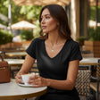 Black V neck tee with short sleeves worn with a gold pendant necklace