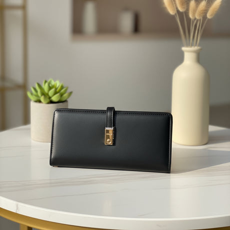 Black wallet on a white table with decorative elements in the background