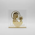 Gold mirrored line art of the Virgin and Child on acrylic with etched Arabic script