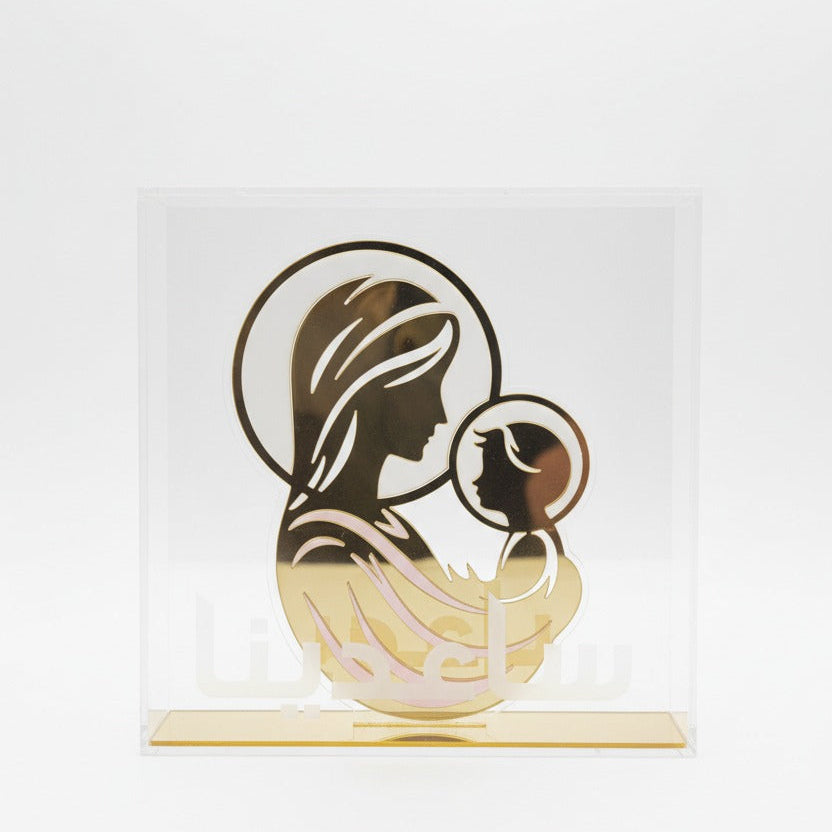 Clear acrylic panel of the Virgin and Child seated in a gold mirrored base bar