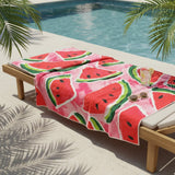 Towel with watermelon design on a lounge chair by a pool