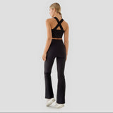 Person wearing a black athletic outfit with a cut-out design on a white background