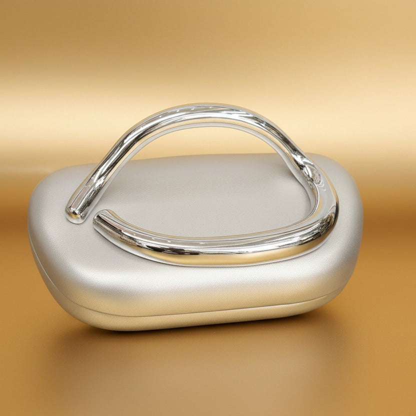 Silver handbag with a handle on a gold gradient background