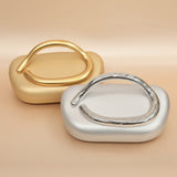 Gold and silver ring-shaped objects on a beige background