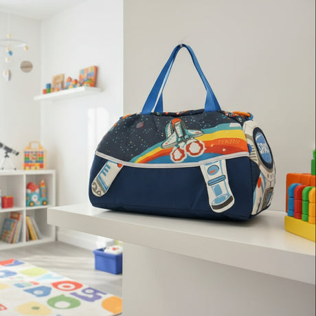 Space-themed duffel bag with blue straps held in a store setting.