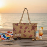 Beach bag with turtle design and 'Beirut' text on a sandy beach with ocean in the background