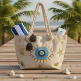 Beach bag with eye design on sand by the ocean