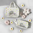 Two clear pouches with floral designs and 'Hello Spring' text, surrounded by flowers on a light background.
