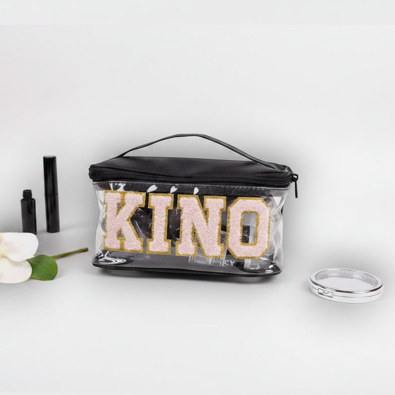 Clear pouch with 'KINOS' branding on a white background with makeup items.