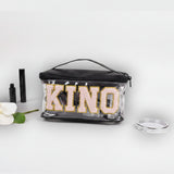 Clear pouch with 'KINOS' branding on a white background with makeup items.