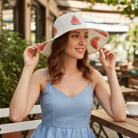 Woman wearing a straw hat with watermelon designs outdoors
