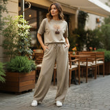 Woman in beige outfit standing outdoors in a casual setting
