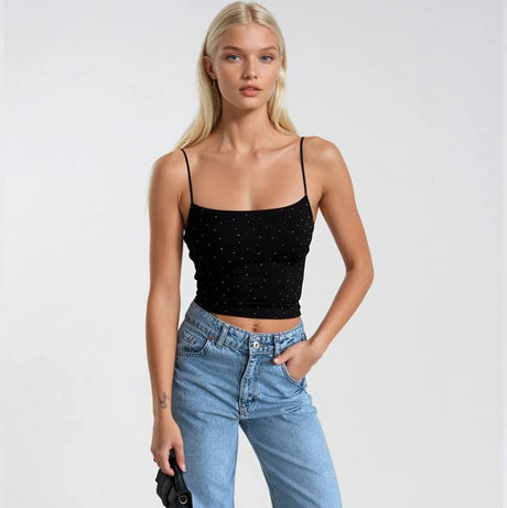Woman wearing a black top and blue jeans on a white background