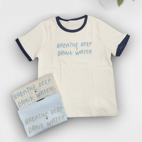 Beige t-shirt with 'Breathe Deep Drink Water' text and matching card on a white background