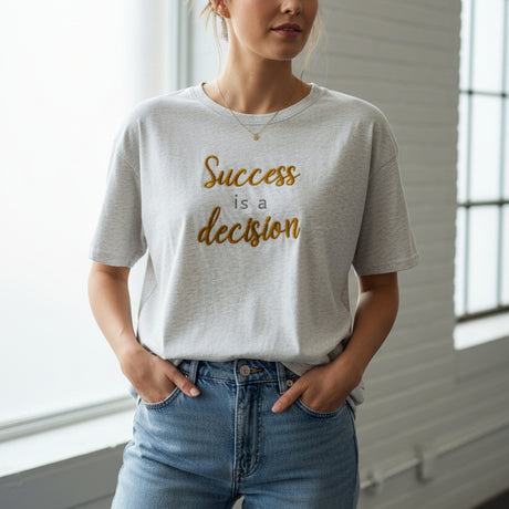Gray t-shirt with 'Success is a decision' text on a dark surface