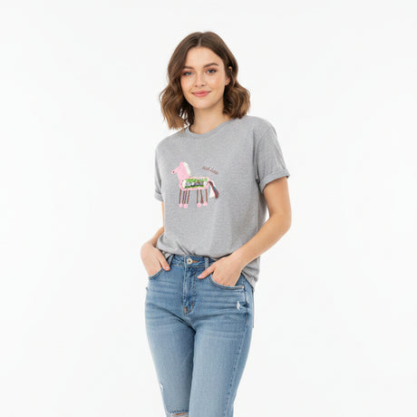 Gray t-shirt with a pink flamingo design on a black surface
