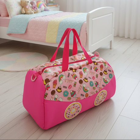 Pink duffel bag with candy-themed design on a wooden floor in a child's bedroom.