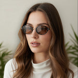 Woman wearing sunglasses with a neutral background