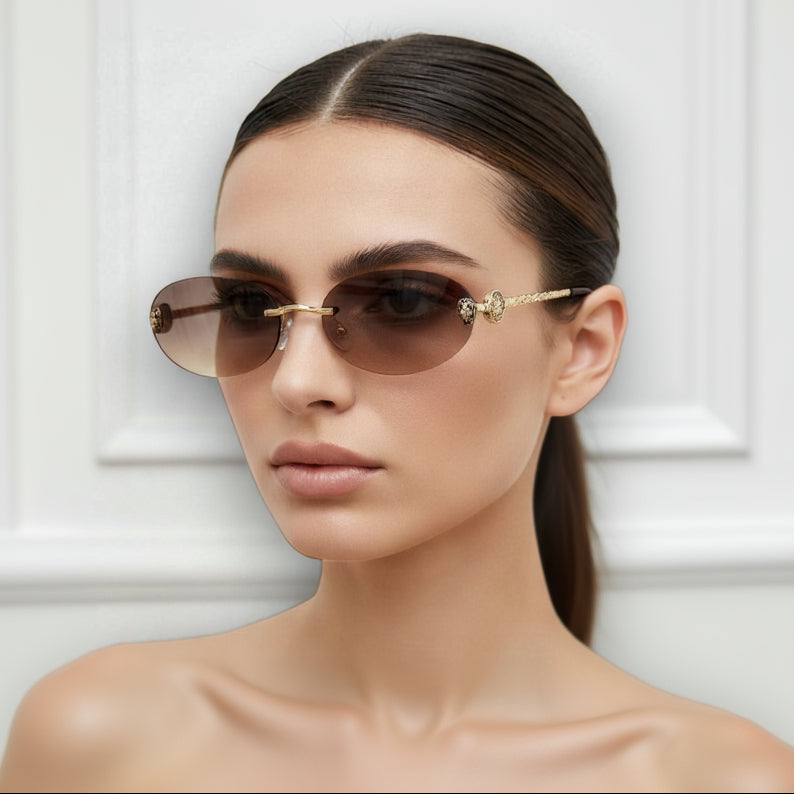 Model wearing gold-framed sunglasses with a neutral background