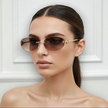 Model wearing gold-framed sunglasses with a neutral background