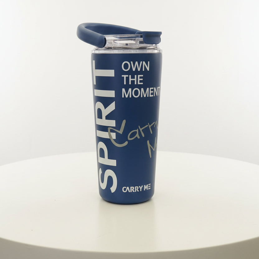 Blue tumbler with motivational text on a white surface