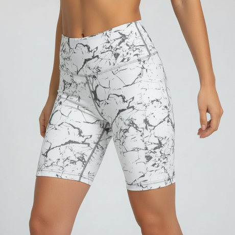 White athletic shorts with black abstract pattern worn by a person on a light gray background