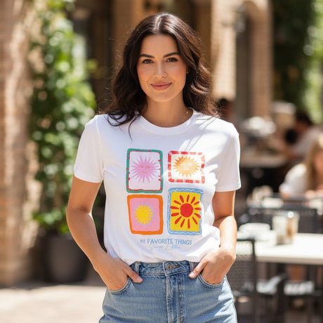 White t-shirt with colorful geometric design on a dark surface