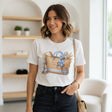 White t-shirt with a decorative design on a dark surface