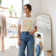 White t-shirt with yellow polka dot design and 'CHIC' text on a dark surface
