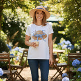 White t-shirt with a decorative hat design on a dark surface