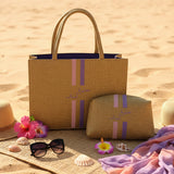 Yellow handbag with pink straps on a wooden surface