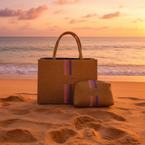 Two woven bags on a sandy beach with a sunset in the background