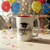 Graduation-themed mug with 'Congrats!' text on a store shelf.