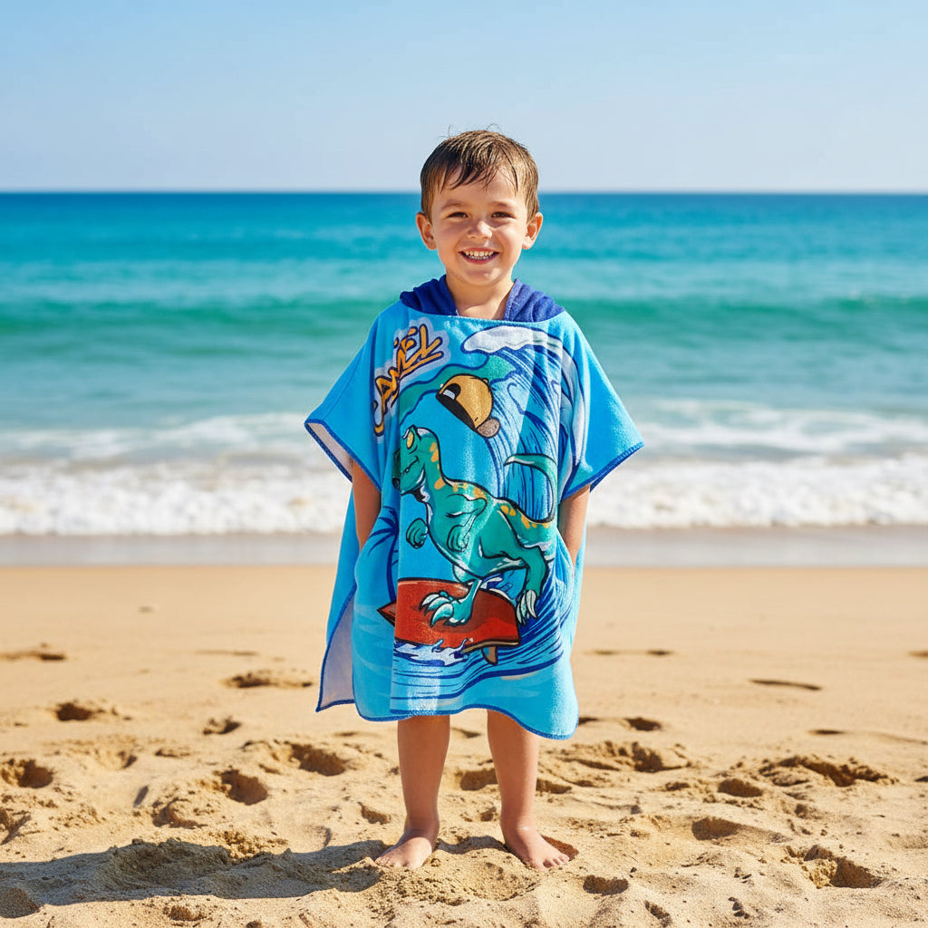 Children's towel with a cartoon dinosaur design on a blue background