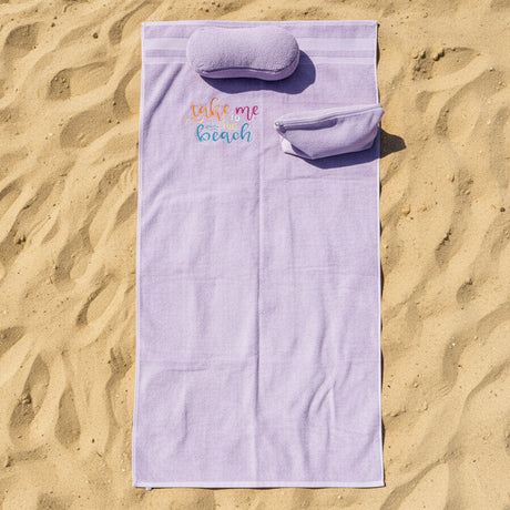 Purple towel with a logo on a gray surface